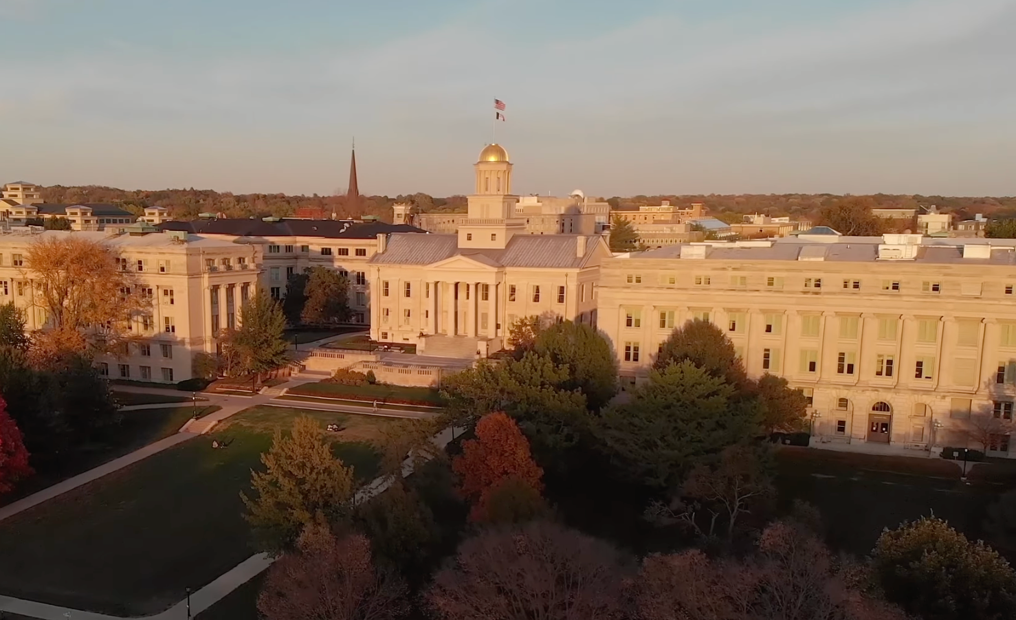 An overhead drone view of the University of Iowa Pentacrest building with trees surrounding it.